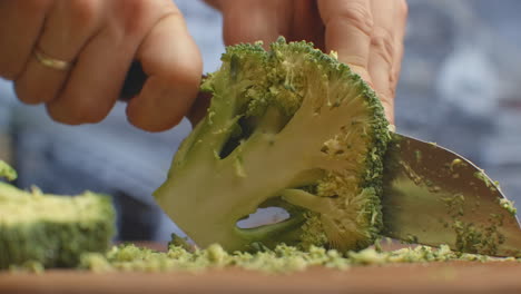 Cut-with-a-knife-on-a-wooden-board-closeup-broccoli-in-the-kitchen.-shred